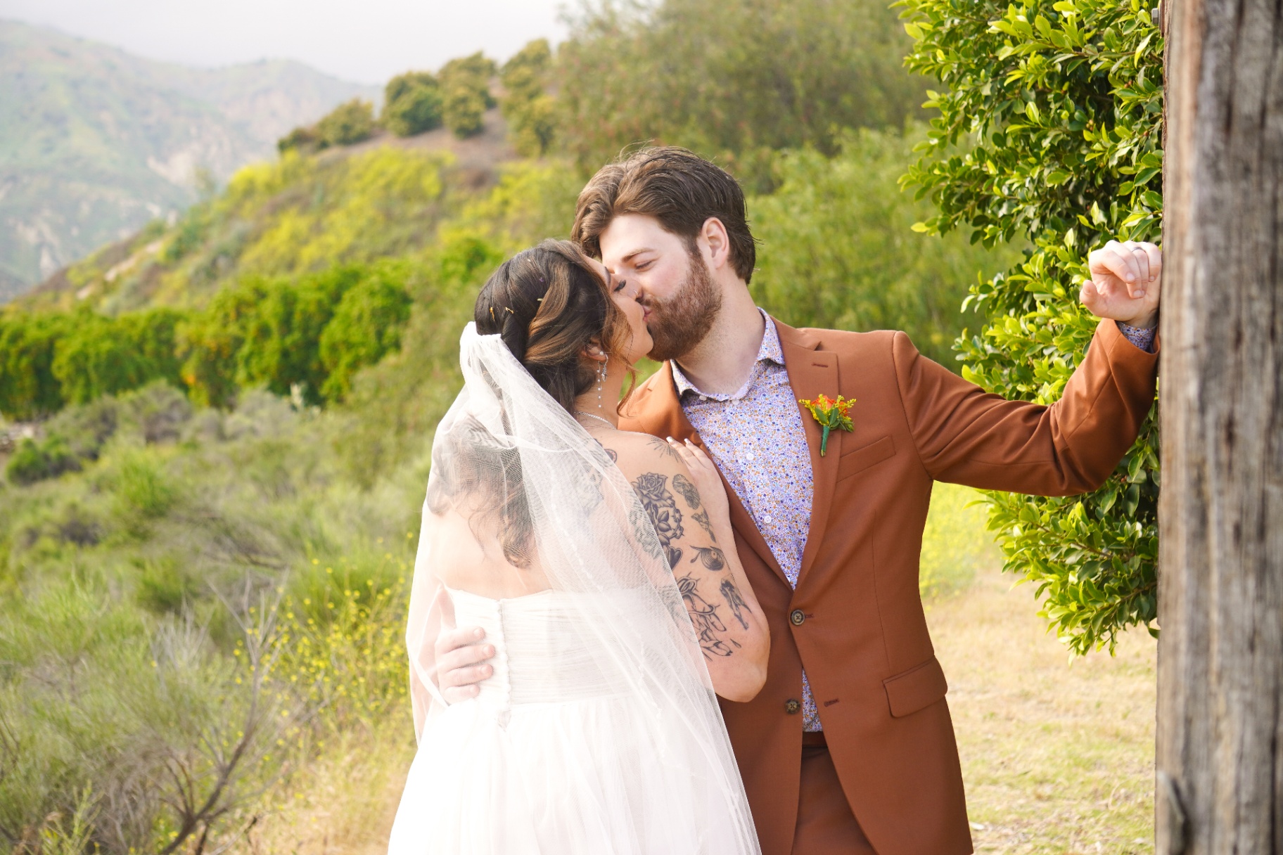 Hillside wedding kiss